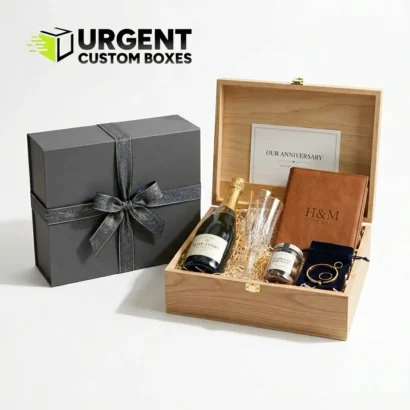 Custom anniversary gift boxes featuring a luxury wooden keepsake box filled with champagne, crystal flutes, and a personalized leather journal