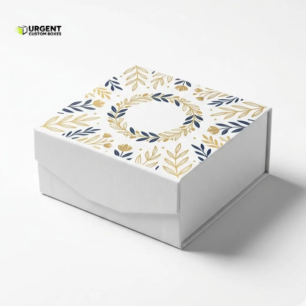 Custom foldable gift boxes in a premium white matte finish featuring an elegant gold and navy blue floral leaf pattern