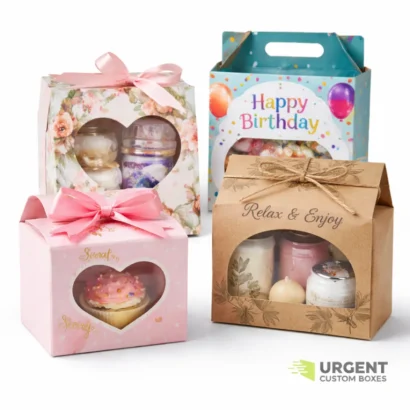 Die-cut gift boxes with clear windows on a white background with Urgent Custom Boxes logo