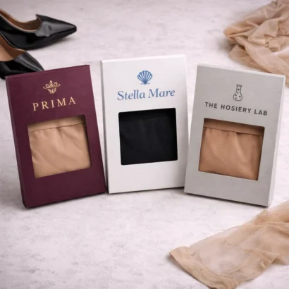 Professional pantyhose packaging boxes with luxury accessories on marble surface