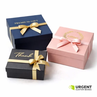 Three elegant foil-stamped gift boxes with ribbons on a white background