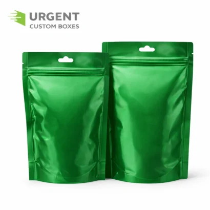 Two green custom Mylar bags with glossy finish and logo in top-left corner