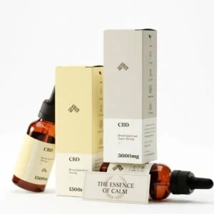 CBD oil dropper bottles and minimalist packaging with a card reading The Essence of Calm